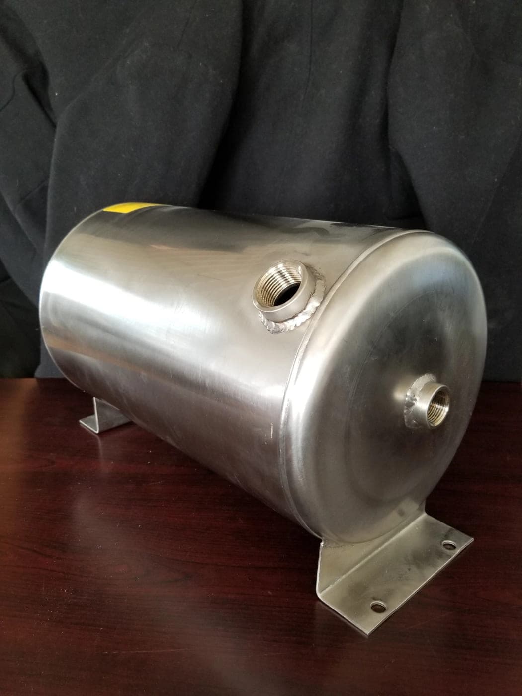 Compact horizontal stainless steel water tank with threaded ports and welded mounting brackets