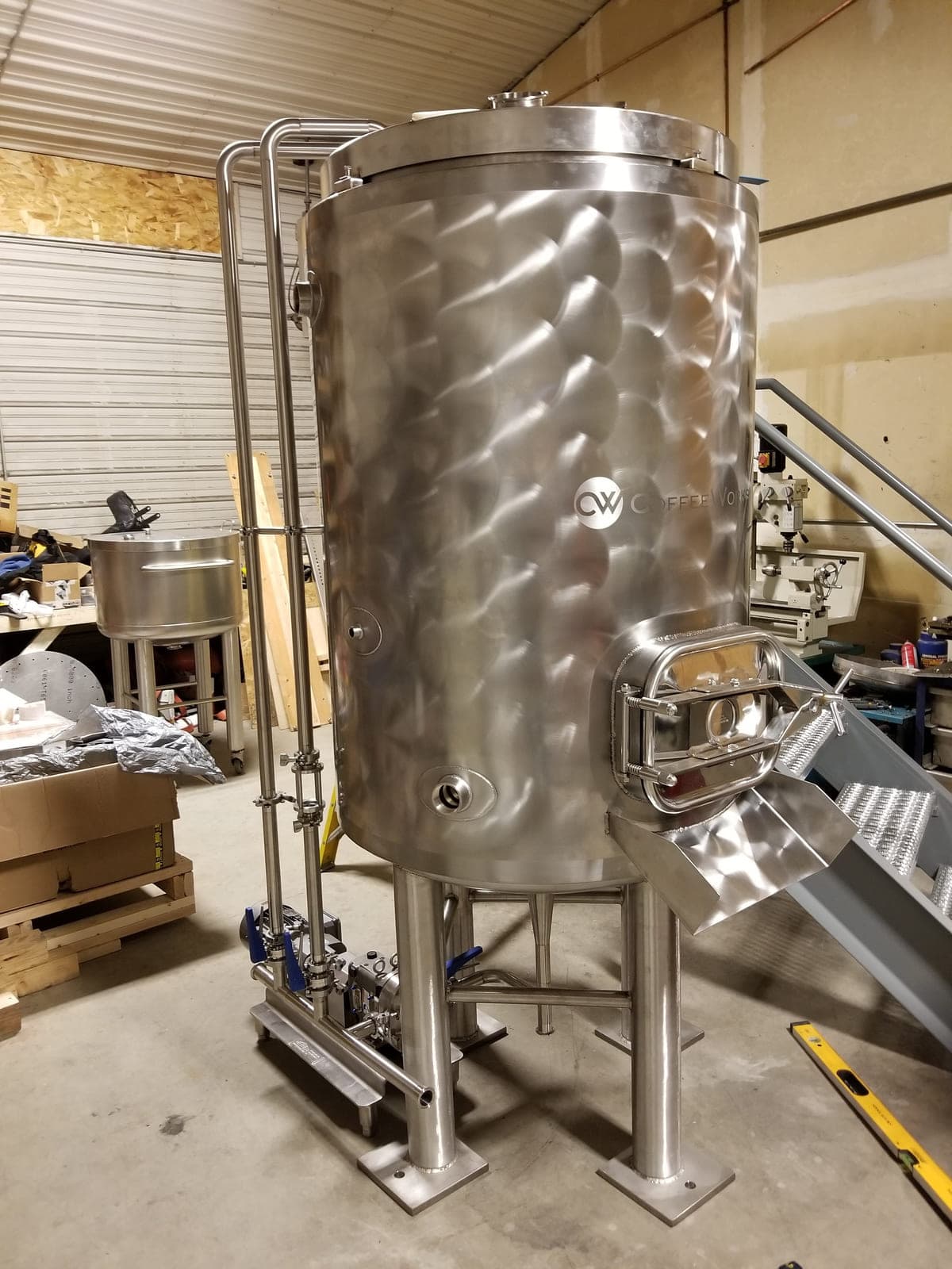 Jacketed stainless steel vertical tank with a side manway and sanitary fittings