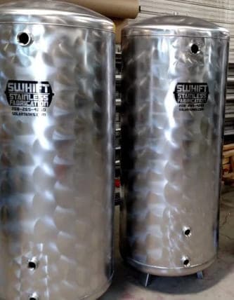 Two Swhift stainless steel tanks in a soft swirl finish, marked with the Swhift logo and phone number